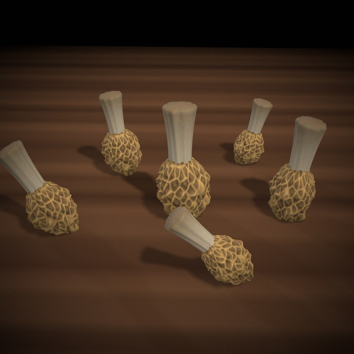 Dried Guchhi morel mushrooms — deeply honeycombed caps on a dark table.