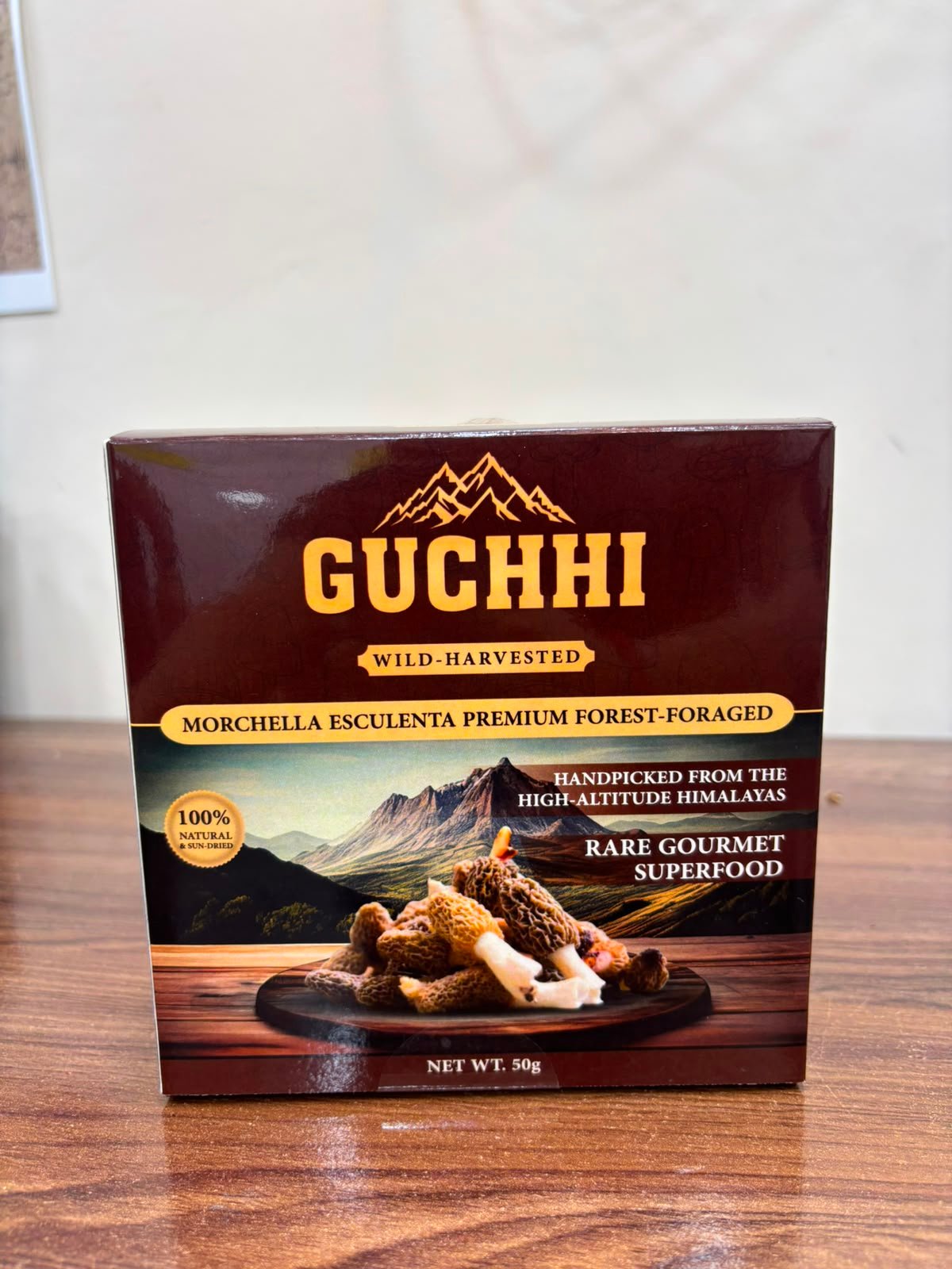 Front of the Guchhi pack showing the gold wordmark and the Himalayan scene.
